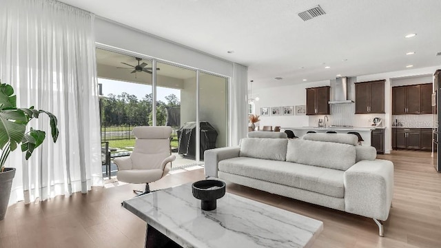 living area featuring visible vents, recessed lighting, light wood finished floors, and ceiling fan