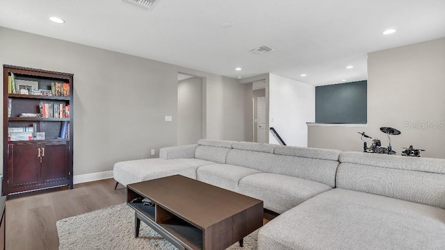 living room with visible vents, recessed lighting, baseboards, and wood finished floors
