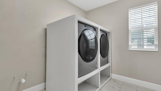 washroom with washer / clothes dryer, baseboards, laundry area, and marble finish floor
