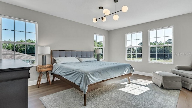 bedroom with baseboards and wood finished floors