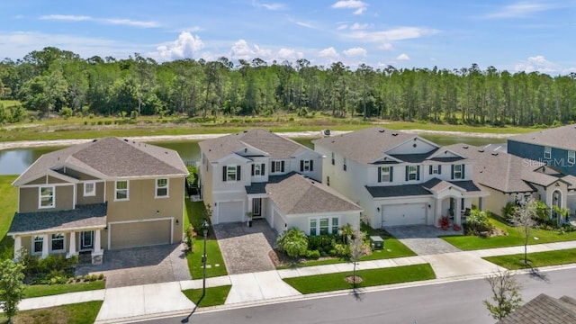bird's eye view featuring a water view, a residential view, and a forest view