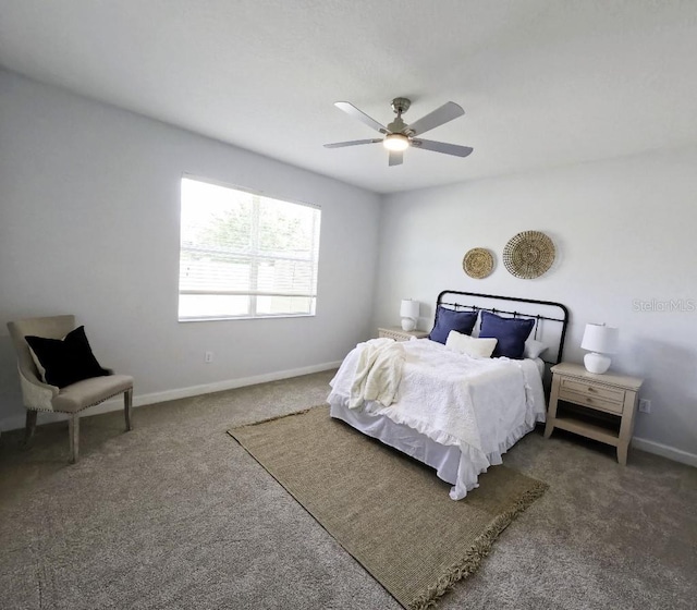 carpeted bedroom featuring baseboards and ceiling fan