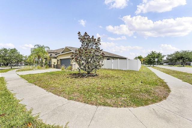 18677 Milton Keynes Ct, Land O Lakes, FL 34638 - view of property exterior with an attached garage, concrete driveway, and stucco siding