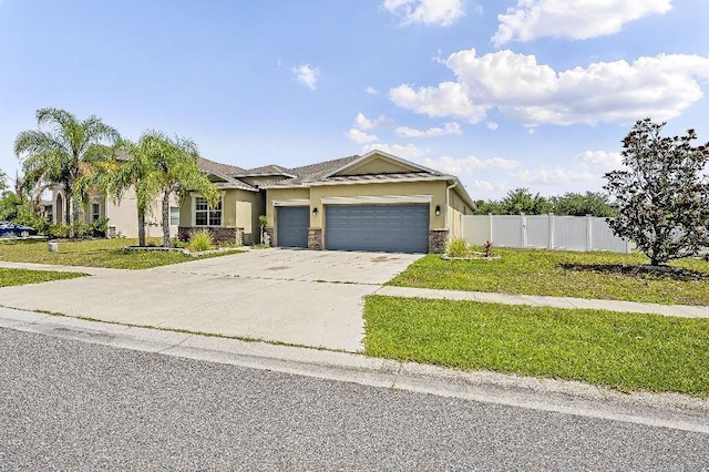 18677 Milton Keynes Ct, Land O Lakes, FL 34638 - view of front of home with stucco siding, a garage, concrete driveway, and stone siding