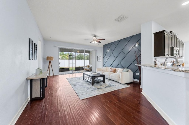 18677 Milton Keynes Ct, Land O Lakes, FL 34638 - living area with a ceiling fan, baseboards, and dark wood finished floors