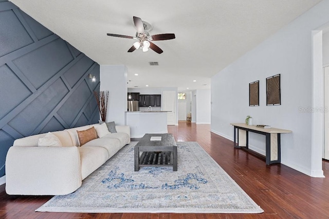 18677 Milton Keynes Ct, Land O Lakes, FL 34638 - living area with ceiling fan, dark wood-type flooring, and baseboards