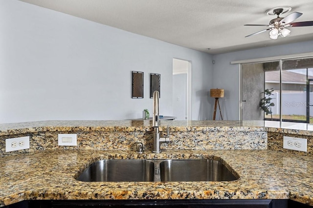 18677 Milton Keynes Ct, Land O Lakes, FL 34638 - kitchen featuring a sink, stone countertops, and a ceiling fan