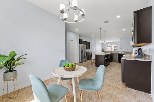 18677 Milton Keynes Ct, Land O Lakes, FL 34638 - dining area with a chandelier, recessed lighting, light tile patterned flooring, and baseboards
