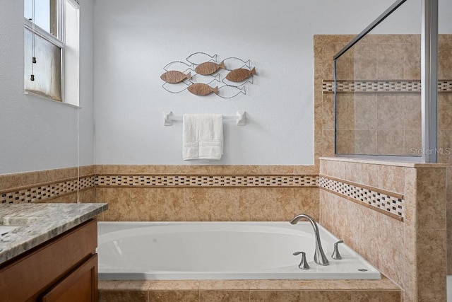 18677 Milton Keynes Ct, Land O Lakes, FL 34638 - full bath featuring a bath, vanity, and tiled shower