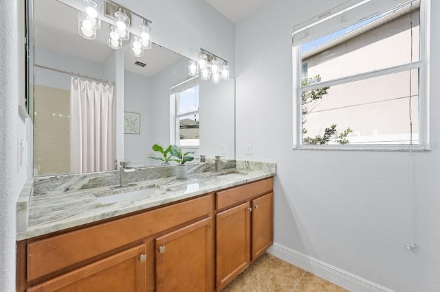 18677 Milton Keynes Ct, Land O Lakes, FL 34638 - bathroom featuring baseboards, double vanity, a shower with shower curtain, and tile patterned floors