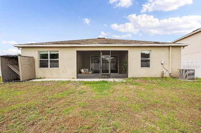 18677 Milton Keynes Ct, Land O Lakes, FL 34638 - back of property featuring central AC, stucco siding, a sunroom, and a yard