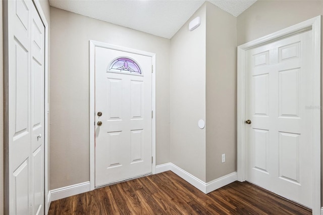 13040 Hanley Dr, Spring Hill, FL 34609 - foyer with dark wood-style flooring and baseboards