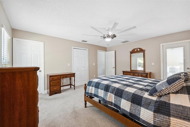 13040 Hanley Dr, Spring Hill, FL 34609 - bedroom featuring multiple windows, light carpet, a closet, a ceiling fan, and a textured ceiling