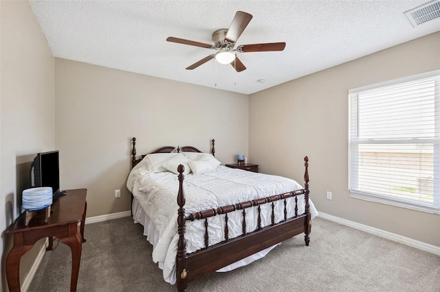 13040 Hanley Dr, Spring Hill, FL 34609 - carpeted bedroom with multiple windows, a textured ceiling, and a ceiling fan