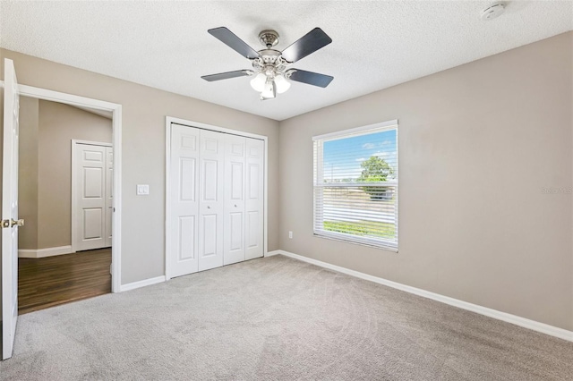 13040 Hanley Dr, Spring Hill, FL 34609 - unfurnished bedroom featuring carpet floors, a closet, ceiling fan, and a textured ceiling