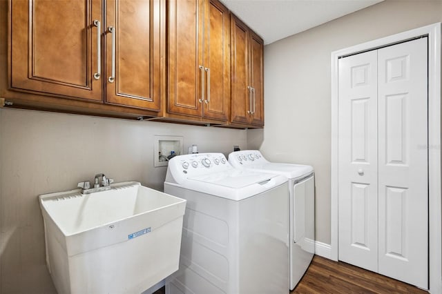 13040 Hanley Dr, Spring Hill, FL 34609 - washroom with cabinet space, washer and clothes dryer, and dark wood finished floors
