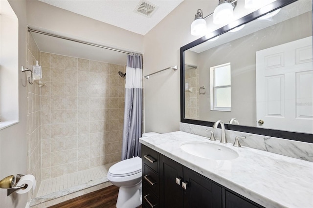 13040 Hanley Dr, Spring Hill, FL 34609 - full bath with vanity, tiled shower, and wood finished floors