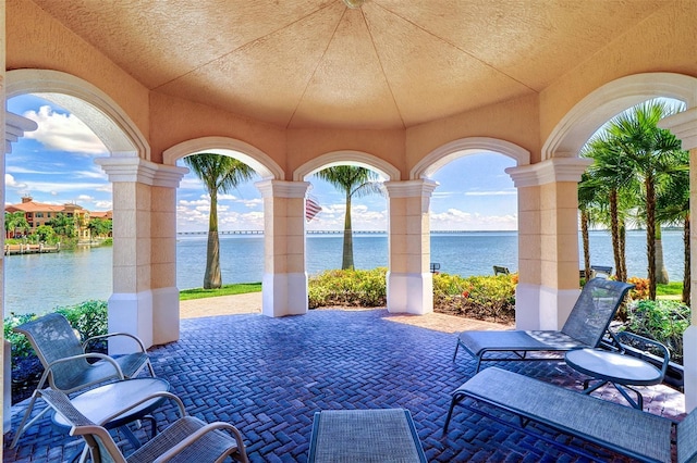 view of patio with a water view