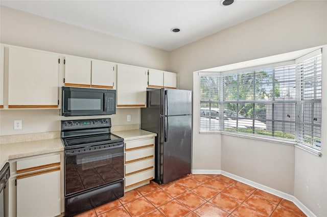 8101 Interbay Blvd Unit A, Tampa, FL 33616 - kitchen with black appliances, healthy amount of natural light, light countertops, and baseboards