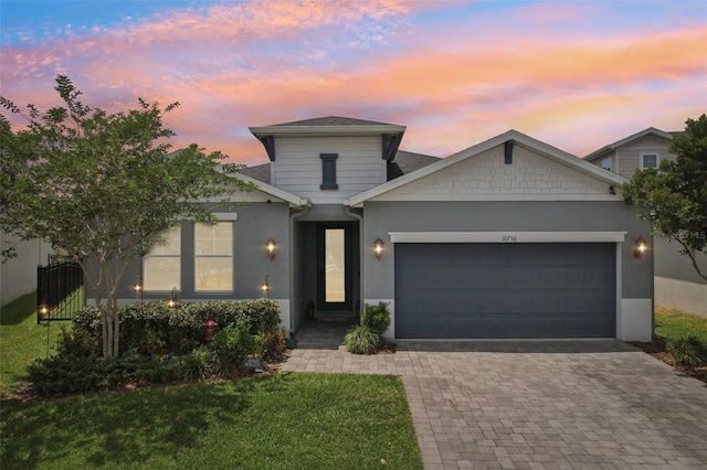 10736 Whitland Grove Dr, Riverview, FL 33578 - view of front facade featuring a garage, decorative driveway, stucco siding, and a lawn