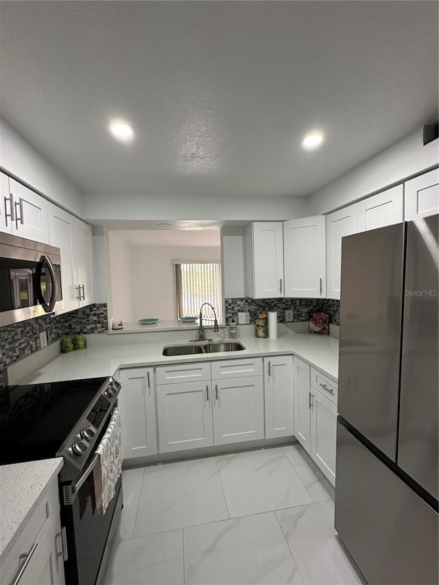 4022 Cortez Dr Unit A, Tampa, FL 33614 - kitchen featuring a sink, appliances with stainless steel finishes, and white cabinets