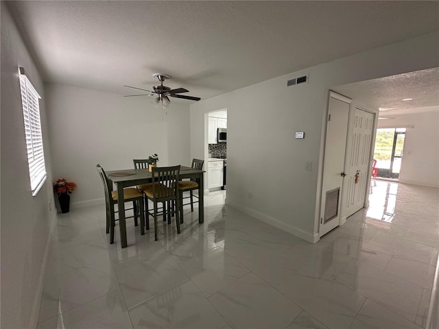 4022 Cortez Dr Unit A, Tampa, FL 33614 - dining space featuring visible vents, marble finish floor, a textured ceiling, and baseboards