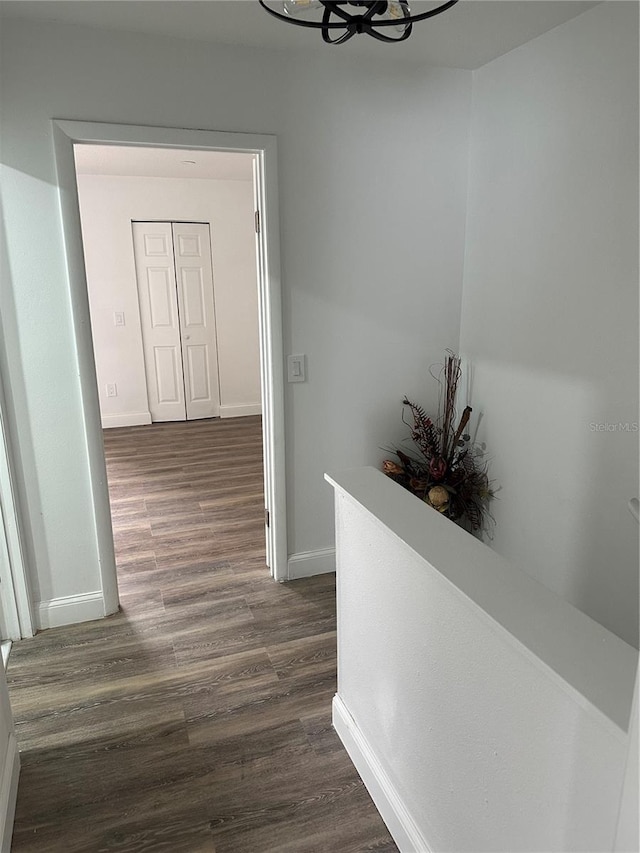 4022 Cortez Dr Unit A, Tampa, FL 33614 - hall featuring baseboards, an upstairs landing, a notable chandelier, and dark wood-type flooring