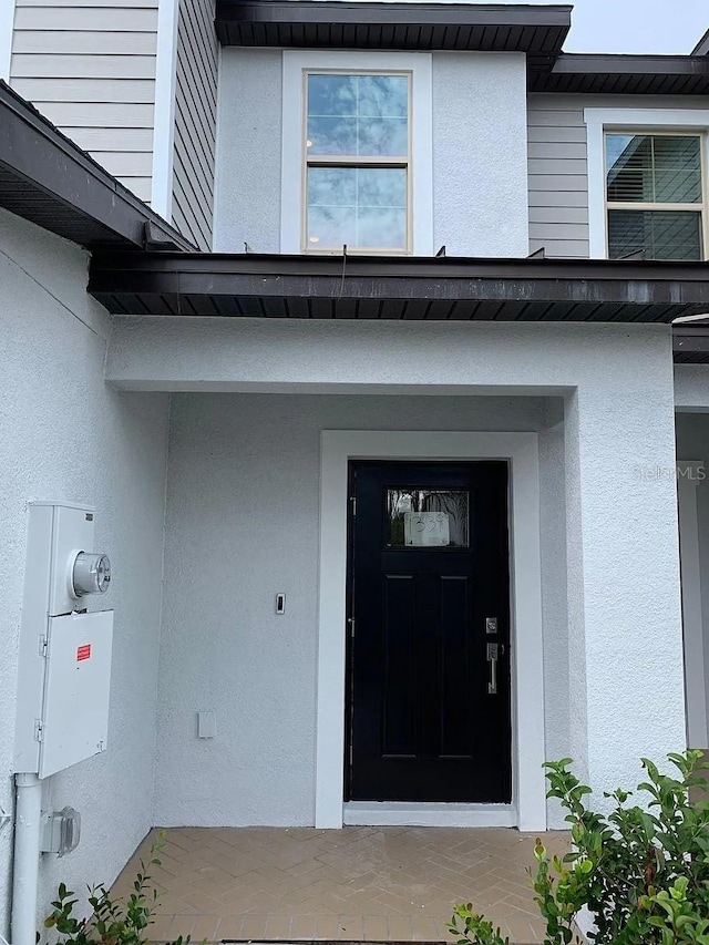 property entrance featuring stucco siding