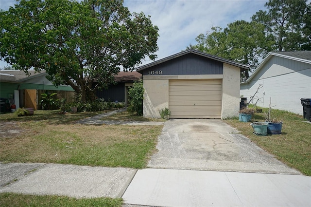 single story home with driveway, a garage, and a front yard