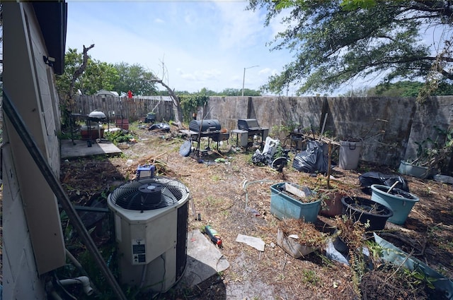 fenced backyard with cooling unit