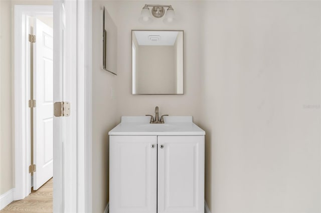 bathroom featuring wood finished floors and vanity