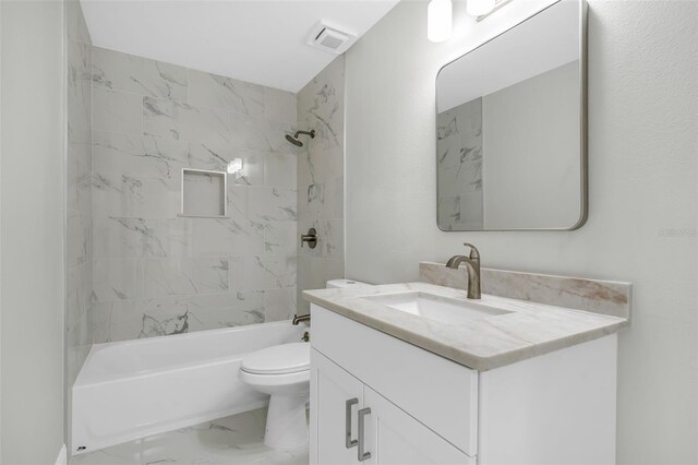 bathroom with visible vents, vanity, toilet, marble finish floor, and washtub / shower combination