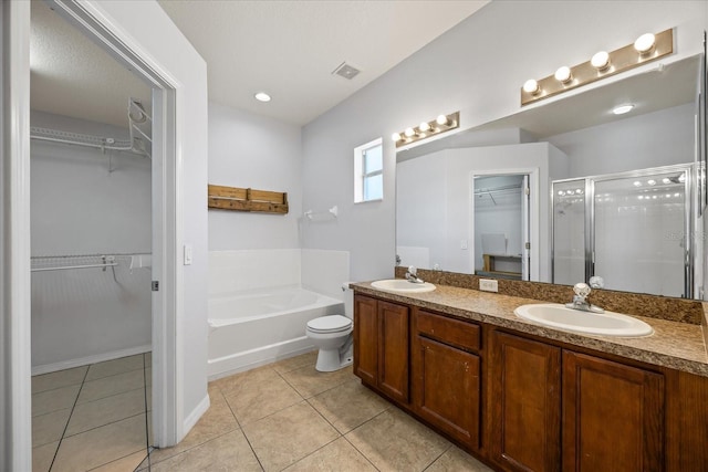 bathroom featuring a sink, a shower stall, and tile patterned floors