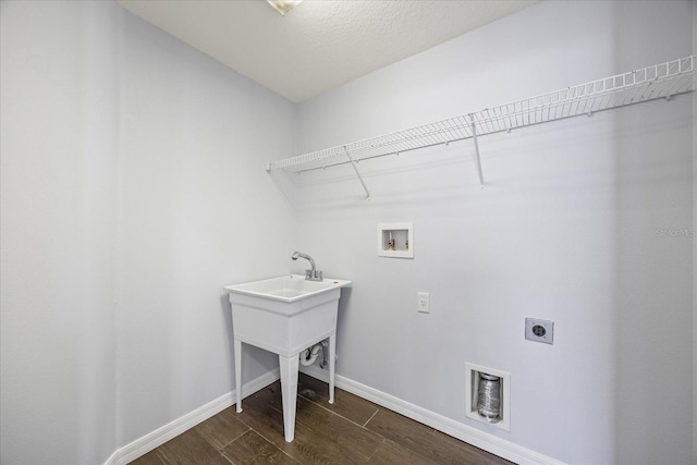 laundry area featuring laundry area, hookup for an electric dryer, dark wood finished floors, baseboards, and hookup for a washing machine