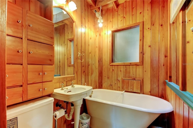 919 Sandpiper Way S, Saint Petersburg, FL 33707 - full bathroom with toilet, wood walls, and a soaking tub