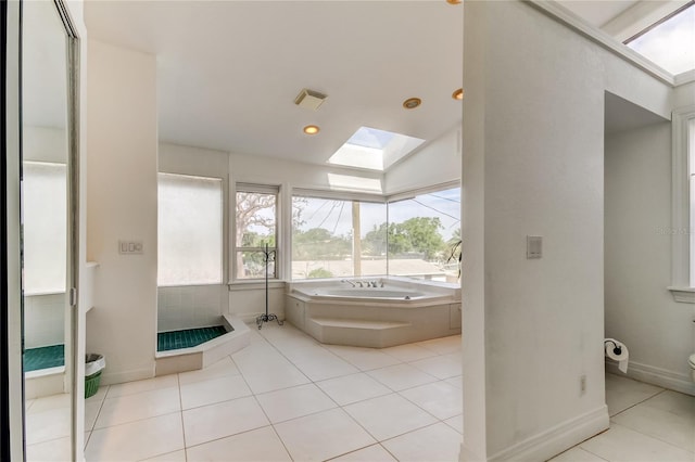 919 Sandpiper Way S, Saint Petersburg, FL 33707 - bathroom with a garden tub, a skylight, visible vents, tile patterned flooring, and walk in shower