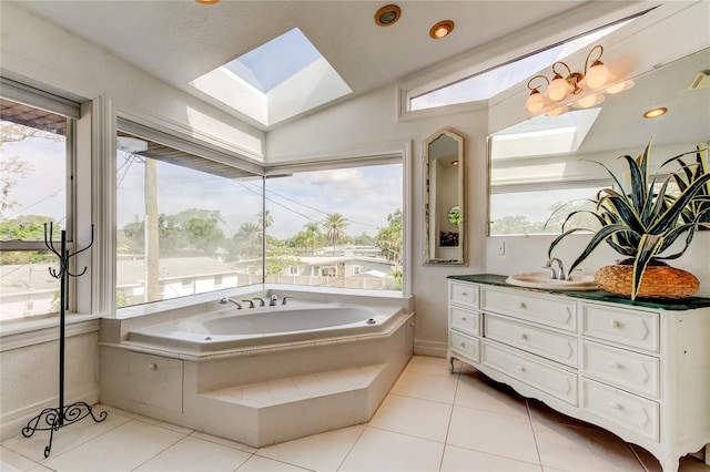 919 Sandpiper Way S, Saint Petersburg, FL 33707 - bathroom featuring vanity, a skylight, a bath, and tile patterned floors