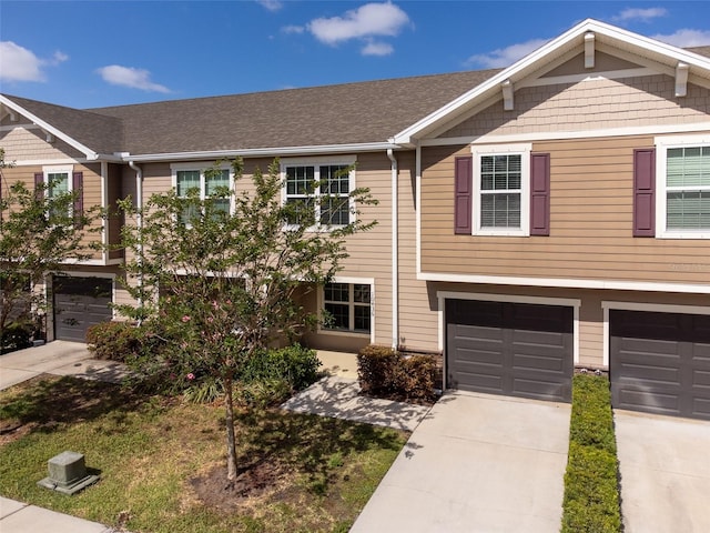 townhome / multi-family property featuring a garage and driveway