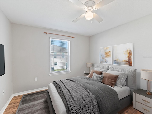 bedroom featuring baseboards, ceiling fan, and wood finished floors