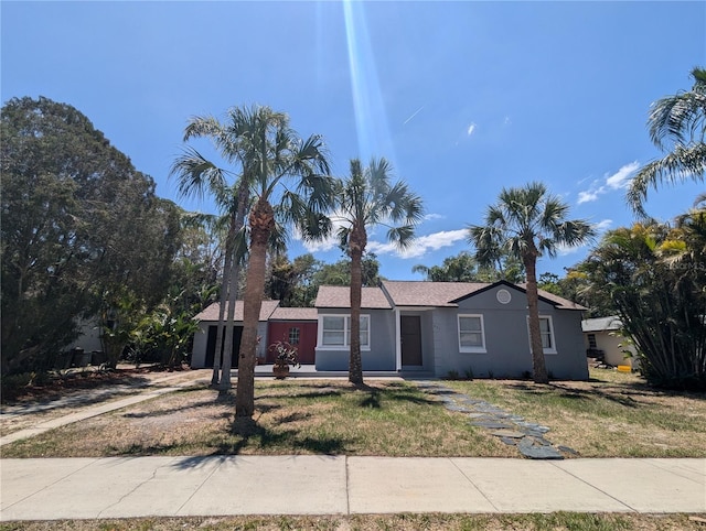 ranch-style home with a front lawn