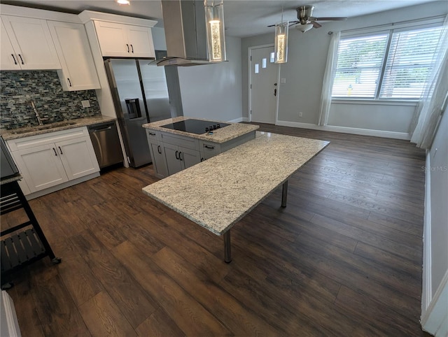 kitchen with appliances with stainless steel finishes, a sink, ceiling fan, a center island, and extractor fan
