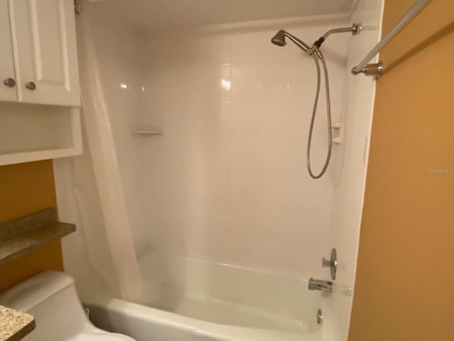 bathroom with toilet and shower / bath combo
