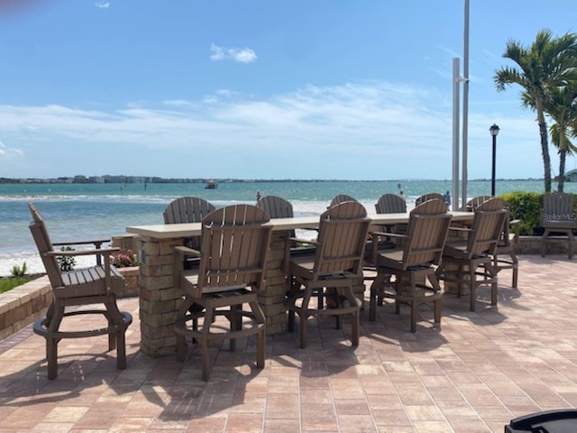 view of patio / terrace with a water view and outdoor dining area