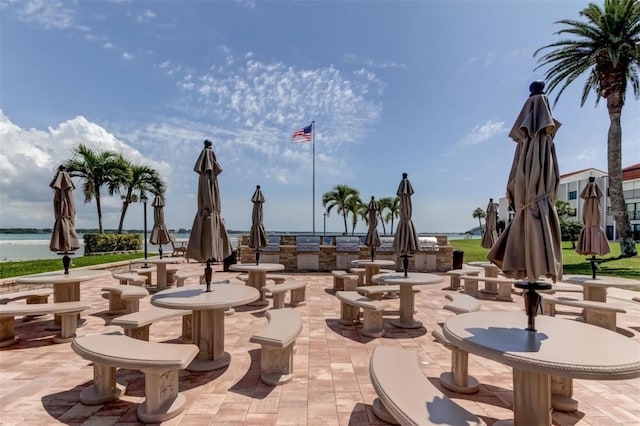 view of property's community featuring a patio and a water view