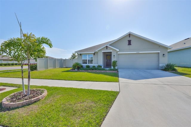 ranch-style home featuring fence, an attached garage, concrete driveway, stucco siding, and a front yard