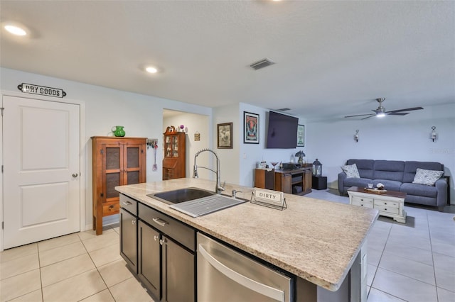 kitchen featuring stainless steel dishwasher, light tile patterned floors, a ceiling fan, and a sink