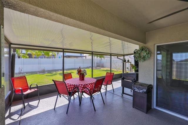 sunroom / solarium featuring outdoor dining area