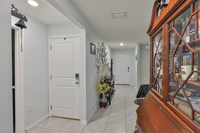 entryway with visible vents, baseboards, light tile patterned flooring, and recessed lighting