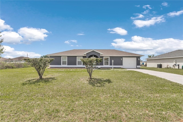 ranch-style home featuring driveway, a garage, and a front lawn