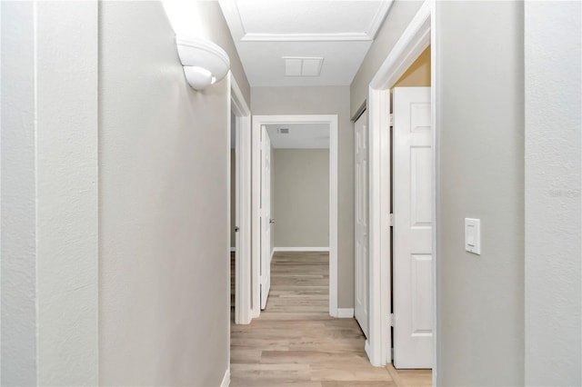 hallway featuring light wood-style floors and baseboards